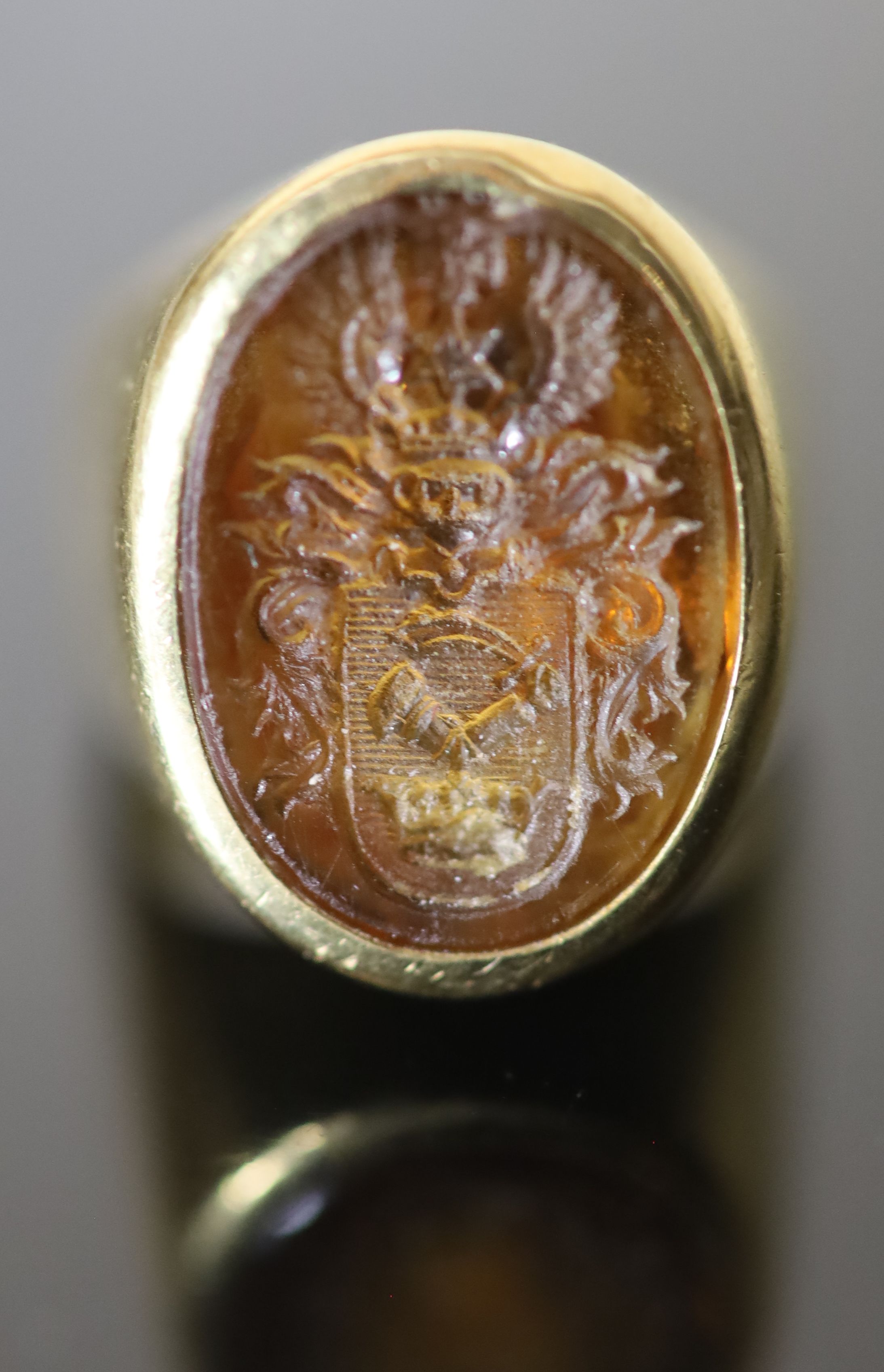 A 20th century continental 18ct gold (stamped 750) and oval citrine? intaglio signet ring,